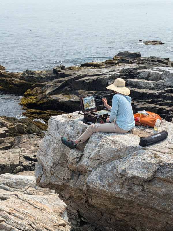 The artist at work on a rock on the shore of Appledore Island, Maine, during an Artist Residency with the Shoals Marine Lab, August 2024.