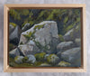 Framed ainting of rocks with green moss in a wooden frame on a textured gray background