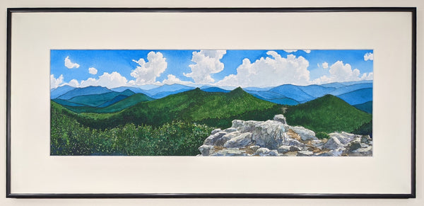 "South from Mount Lafayette" is a 7 by 21 inch watercolor and ink painting on paper depicting the view south along the Franconia Ridge Trail in the White Mountains of New Hampshire. A rocky outcrop in the foreground opens up to the peaks of Haystack, Lincoln and Liberty beyond, with rows of distant blue mountains as the backdrop. This is a framed view of the artwork.