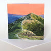 Mount Lafayette, on the northern end of the Franconia Ridge, is one iconic summit. Many hikers know this pyramidal peak with the trail winding up its slopes. Here I've surrounded it with the glowing oranges and yellows of a summer sunset.  Square 5"x5" greeting cards. High quality prints of original paintings on archival felted cardstock. Certified by the Forest Stewardship Council. Envelopes are included.